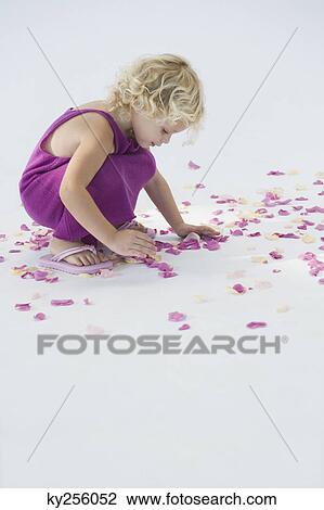 Girl picking up flower petals View Large Photo Image Stock Image - Girl picking up flower petals. Fotosearch