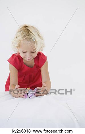 Girl playing with artificial butterflies View Large Photo Image Stock Photo - Girl playing with artificial butterflies. Fotosearch