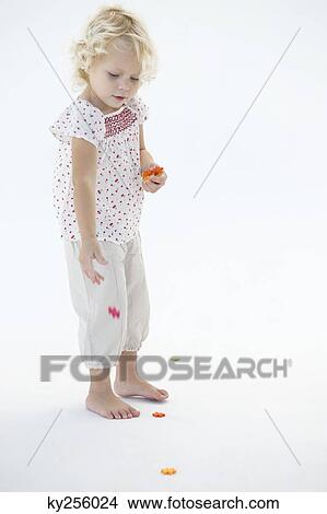 Girl playing with flowers View Large Photo Image Picture - Girl playing with flowers. Fotosearch