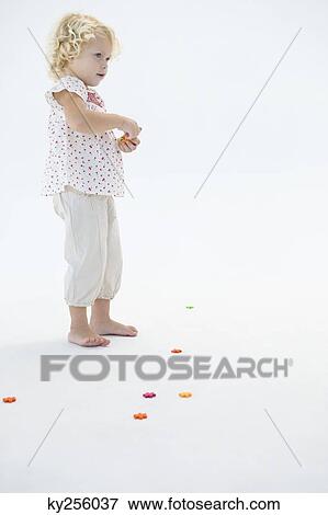 Girl playing with flowers View Large Photo Image Stock Photo - Girl playing with flowers. Fotosearch