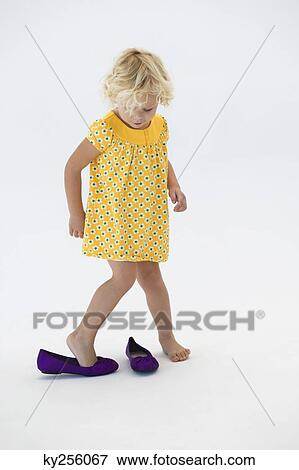 Girl putting on shoes View Large Photo Image Stock Photo - Girl putting on shoes. Fotosearch