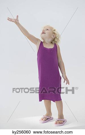 Girl standing with her hand raised View Large Photo Image Stock Image - Girl standing with her hand raised. Fotosearch