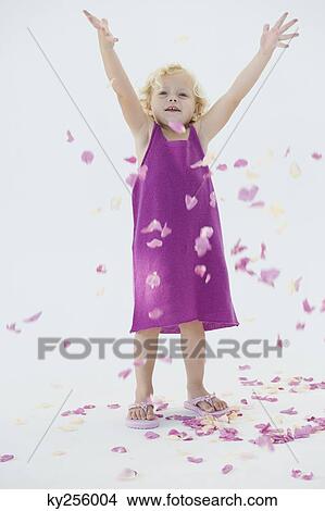 Girl tossing flower petals and smiling View Large Photo Image Picture - Girl tossing flower petals and smiling. Fotosearch