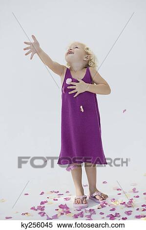 Girl tossing flower petals and smiling View Large Photo Image Stock Photography - Girl tossing flower petals and smiling. Fotosearch