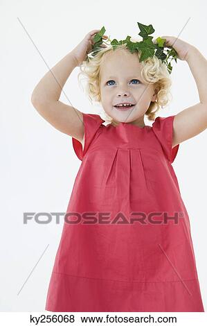 Girl wearing a wreath and smiling View Large Photo Image Stock Photo - Girl wearing a wreath and smiling. Fotosearch
