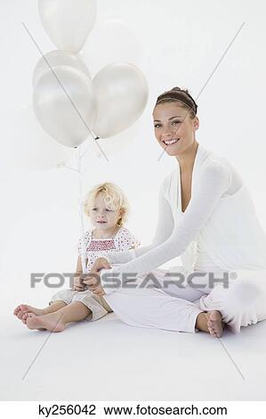 Woman giving balloons to her daughter View Large Photo Image Stock Image - Woman giving balloons to her daughter. Fotosearch
