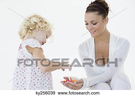Stock Photo - Woman giving flowers to her daughter. Fotosearch