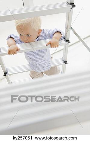 Baby boy climbing a step ladder View Large Photo Image Stock Image - Baby boy climbing a step ladder. Fotosearch