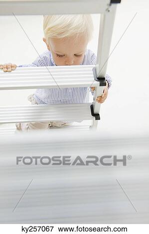 Baby boy climbing a step ladder View Large Photo Image Stock Photo - Baby boy climbing a step ladder. Fotosearch