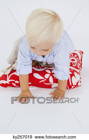 Baby boy crawling on a cushion View Large Photo Image Stock Photo - Baby boy crawling on a cushion. Fotosearch