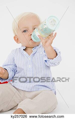 Baby boy drinking water from a baby bottle View Large Photo Image Stock Photograph - Baby boy drinking water from a baby bottle. Fotosearch