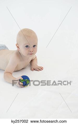 Baby boy holding a ball View Large Photo Image Stock Image - Baby boy holding a ball. Fotosearch