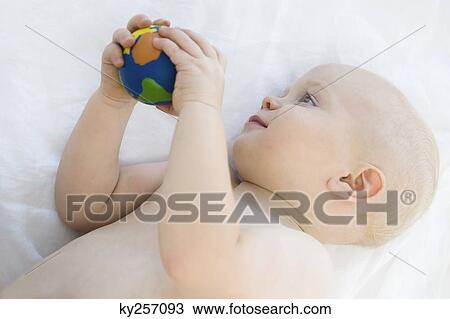 Baby boy holding a ball View Large Photo Image Stock Image - Baby boy holding a ball. Fotosearch