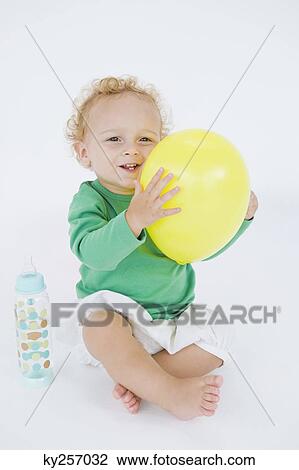 Baby boy holding a balloon View Large Photo Image Stock Image - Baby boy holding a balloon. Fotosearch