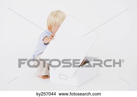 Baby boy opening a box View Large Photo Image Picture - Baby boy opening a box. Fotosearch