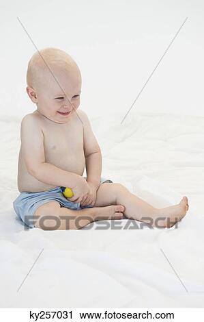 Baby boy playing with a ball View Large Photo Image Stock Image - Baby boy playing with a ball. Fotosearch
