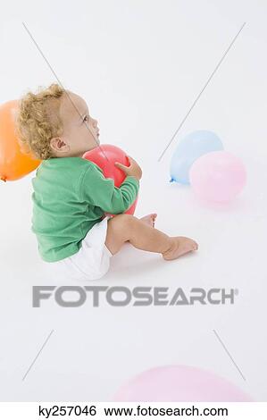 Baby boy playing with a balloon View Large Photo Image Stock Photograph - Baby boy playing with a balloon. Fotosearch