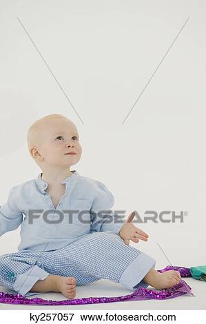 Baby boy playing with a ribbon View Large Photo Image Stock Photo - Baby boy playing with a ribbon. Fotosearch