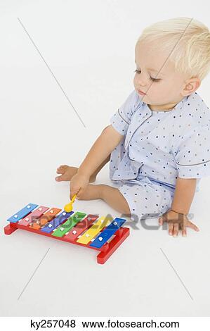 Stock Photo - Baby boy playing with a xylophone. Fotosearch
