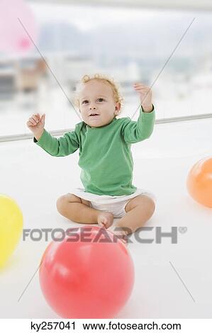 Baby boy playing with balloons View Large Photo Image Stock Image - Baby boy playing with balloons. Fotosearch