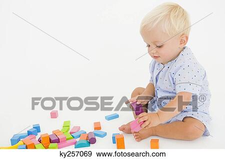 Baby boy playing with blocks View Large Photo Image Stock Photo - Baby boy playing with blocks. Fotosearch