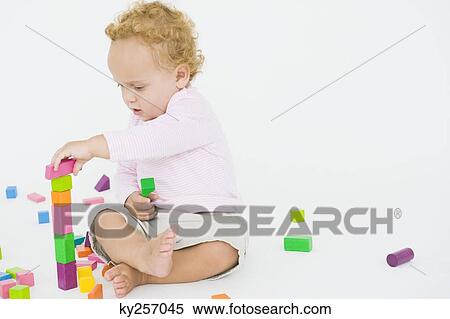 Stock Photography - Baby boy playing with blocks. Fotosearch