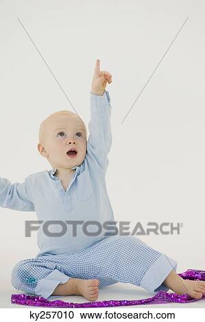Stock Image - Baby boy pointing upward. Fotosearch