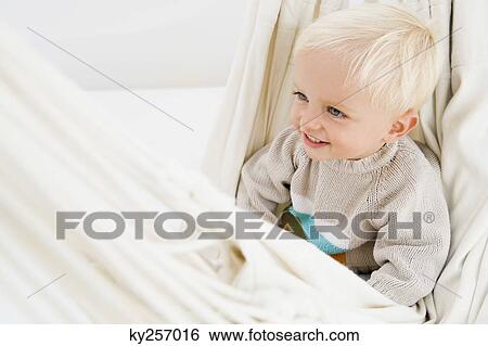Baby boy sitting in a hammock View Large Photo Image Stock Photograph - Baby boy sitting in a hammock. Fotosearch