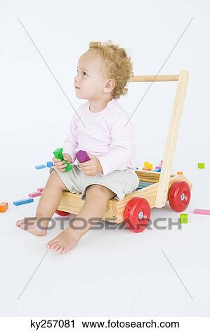 Baby boy sitting on a push cart View Large Photo Image Stock Image - Baby boy sitting on a push cart. Fotosearch
