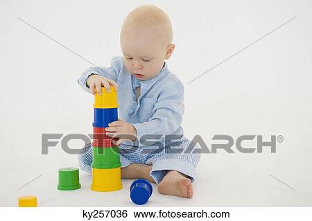 Stock Photograph - Baby boy stacking blocks. Fotosearch