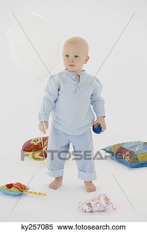 Baby boy standing with toys View Large Photo Image Stock Photography - Baby boy standing with toys. Fotosearch
