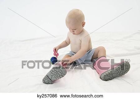 Baby boy wearing rubber boots View Large Photo Image Stock Photograph - Baby boy wearing rubber boots. Fotosearch
