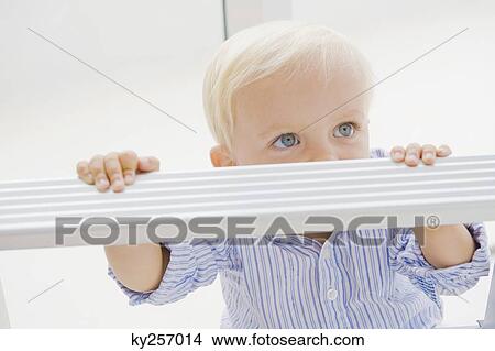 Picture - Baby boy with a step ladder. Fotosearch