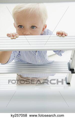 Baby boy with a step ladder View Large Photo Image Stock Photo - Baby boy with a step ladder. Fotosearch