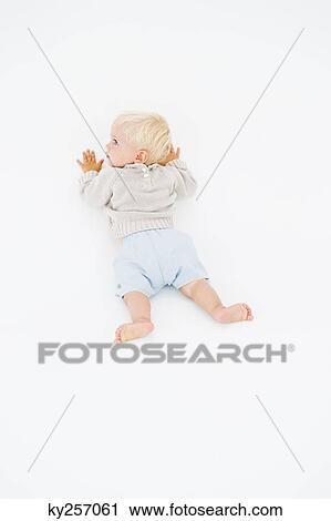 Stock Image - High angle view of a baby boy crawling. Fotosearch