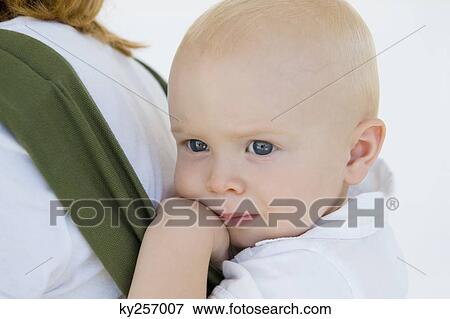 Woman carrying her son in a baby carrier View Large Photo Image Stock Photo - Woman carrying her son in a baby carrier. Fotosearch