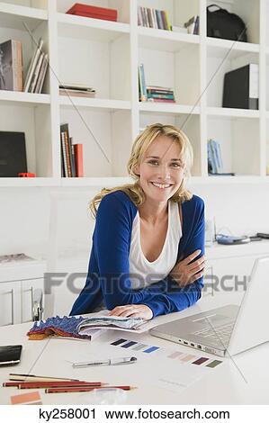 Businesswoman choosing color swatches and smiling View Large Photo Image Stock Image - Businesswoman choosing color swatches and smiling. Fotosearch
