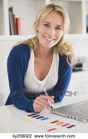 Businesswoman choosing color swatches and smiling View Large Photo Image Stock Image - Businesswoman choosing color swatches and smiling. Fotosearch