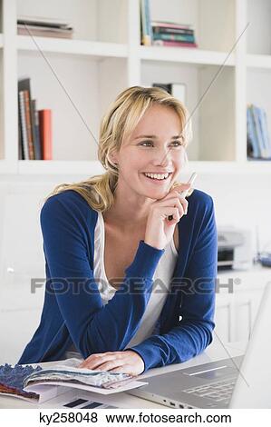 Businesswoman choosing color swatches and smiling View Large Photo Image Stock Photo - Businesswoman choosing color swatches and smiling. Fotosearch