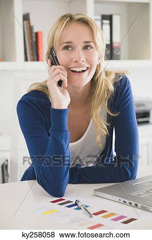 Stock Photo - Businesswoman talking on a mobile phone. Fotosearch