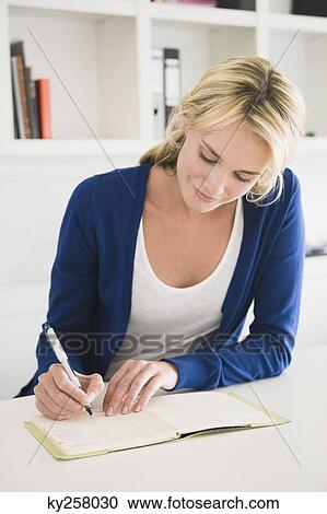 Businesswoman writing on a notepad View Large Photo Image Stock Image - Businesswoman writing on a notepad. Fotosearch