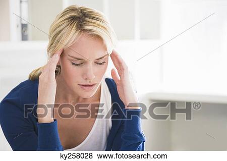 Stock Photo - Close-up of a woman with head in hands. Fotosearch