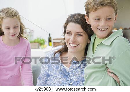 Close-up of a woman smiling with their children View Large Photo Image Stock Image - Close-up of a woman smiling with their children. Fotosearch