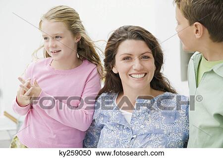 Close-up of a woman smiling with their children View Large Photo Image Stock Image - Close-up of a woman smiling with their children. Fotosearch