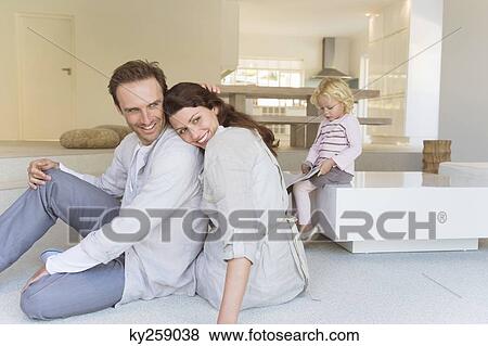Stock Photo - Couple sitting on the floor. Fotosearch