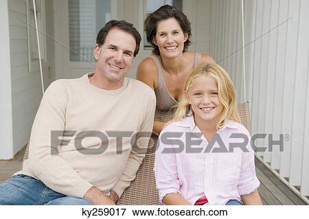 Couple smiling with their daughter View Large Photo Image Stock Photo - Couple smiling with their daughter. Fotosearch