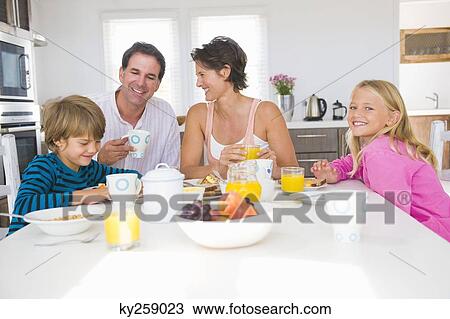 Family having breakfast at the dining table View Large Photo Image Stock Image - Family having breakfast at the dining table. Fotosearch