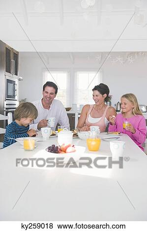 Family having breakfast at the dining table View Large Photo Image Stock Photo - Family having breakfast at the dining table. Fotosearch