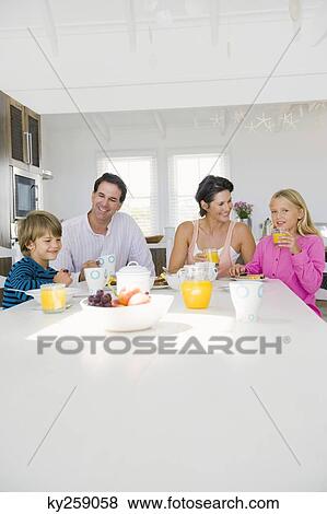 Family having breakfast at the dining table View Large Photo Image Stock Photo - Family having breakfast at the dining table. Fotosearch
