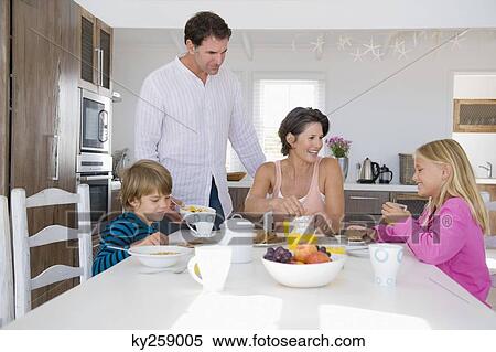 Family having breakfast at the dining table View Large Photo Image Stock Photography - Family having breakfast at the dining table. Fotosearch